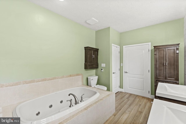 26471 N Sandgates Rd, Mechanicsville, MD 20659 - full bathroom with a tub with jets, vanity, toilet, and wood finished floors