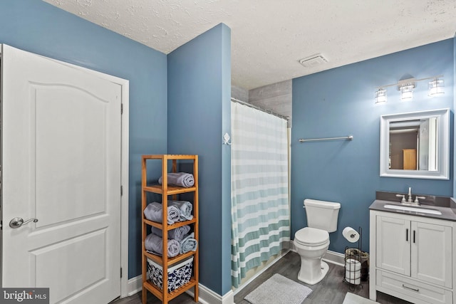 26471 N Sandgates Rd, Mechanicsville, MD 20659 - full bathroom featuring toilet, vanity, a textured ceiling, wood finished floors, and baseboards