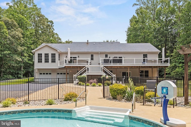 26471 N Sandgates Rd, Mechanicsville, MD 20659 - back of house featuring stairs, a wooden deck, an attached garage, roof with shingles, and driveway