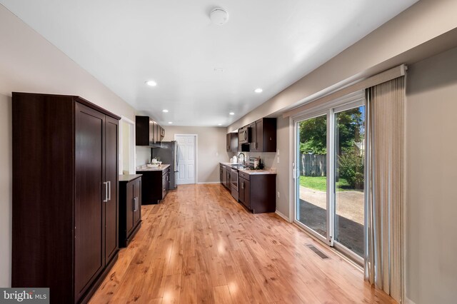 3011 Spark Ln, Bowie, MD 20715 - kitchen featuring light countertops, dark brown cabinets, light wood-style flooring, stainless steel appliances, and recessed lighting