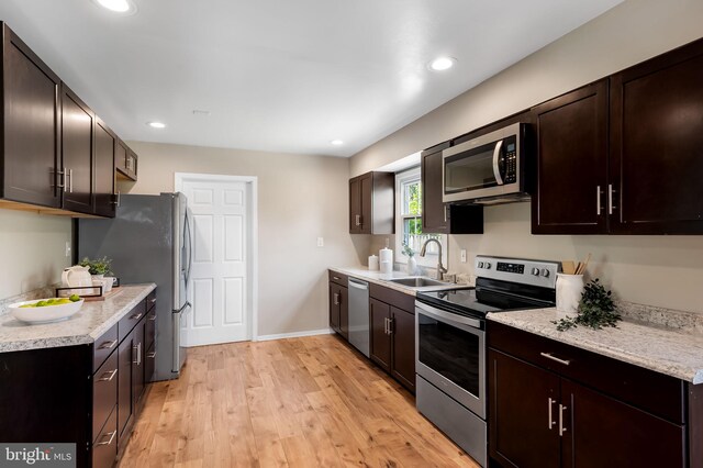 3011 Spark Ln, Bowie, MD 20715 - kitchen with appliances with stainless steel finishes, light countertops, light wood-style flooring, recessed lighting, and dark brown cabinets