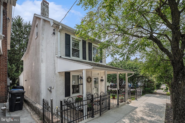453 Old Elm St, Conshohocken, PA 19428 - view of front of home featuring stucco siding, a chimney, and covered porch