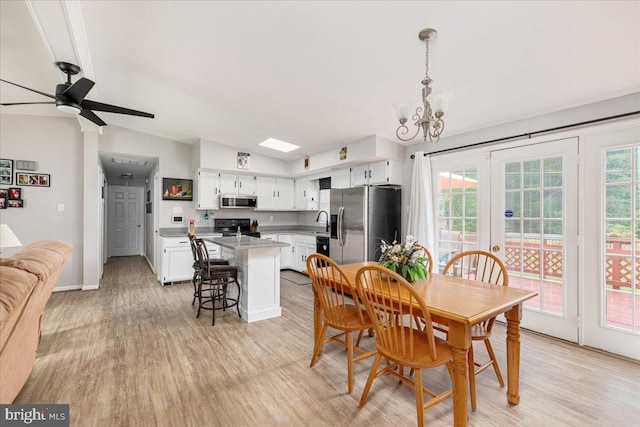 102 Winnepeg Pl, Winchester, VA 22603 - dining space with lofted ceiling, light wood finished floors, a chandelier, ceiling fan, and baseboards