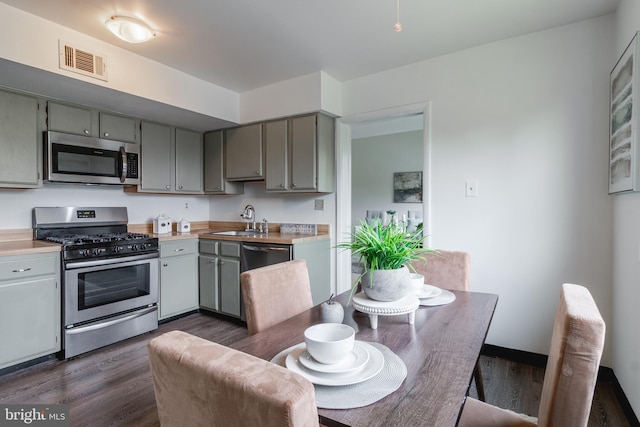11510 Bucknell Dr Unit 201, Silver Spring, MD 20902 - kitchen with stainless steel appliances, gray cabinets, dark wood-type flooring, and light countertops