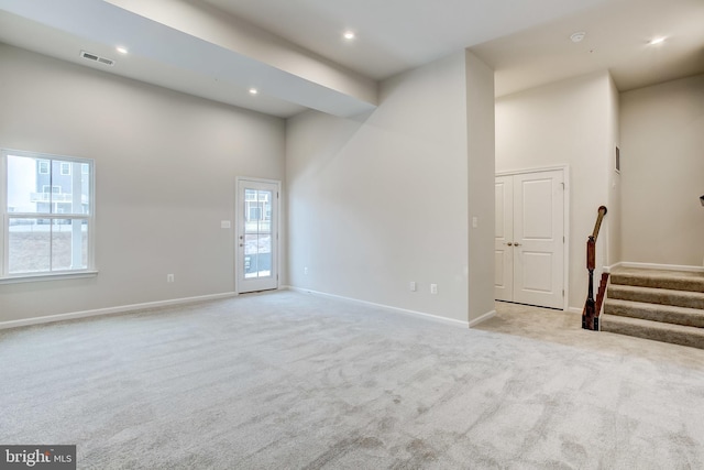 9608 Julia Ln, Owings Mills, MD 21117 - unfurnished room with light carpet, a towering ceiling, stairs, baseboards, and recessed lighting