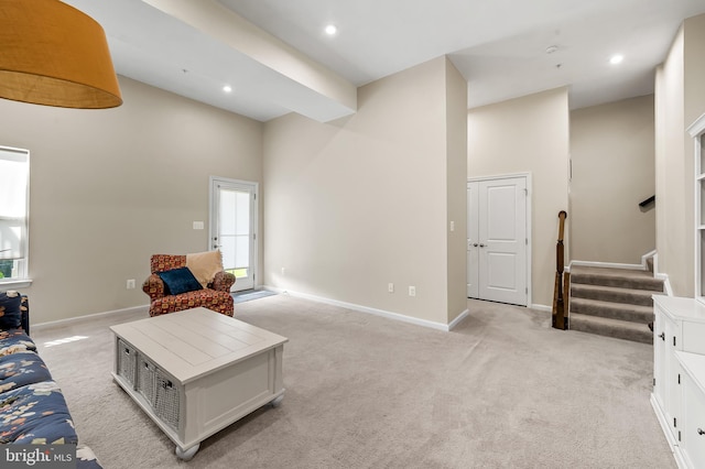 9608 Julia Ln, Owings Mills, MD 21117 - living area featuring light carpet, high vaulted ceiling, stairs, baseboards, and recessed lighting