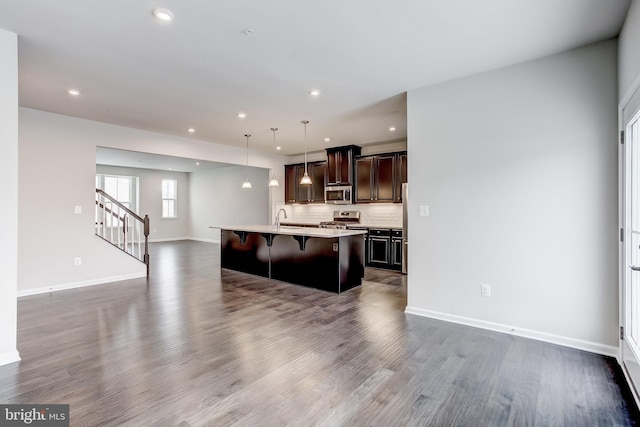 9608 Julia Ln, Owings Mills, MD 21117 - kitchen with appliances with stainless steel finishes, open floor plan, a breakfast bar, recessed lighting, and dark wood-type flooring