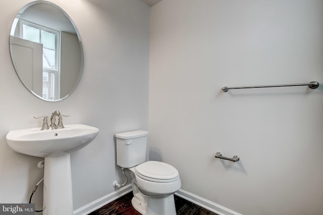 9608 Julia Ln, Owings Mills, MD 21117 - half bathroom with toilet, wood finished floors, and baseboards