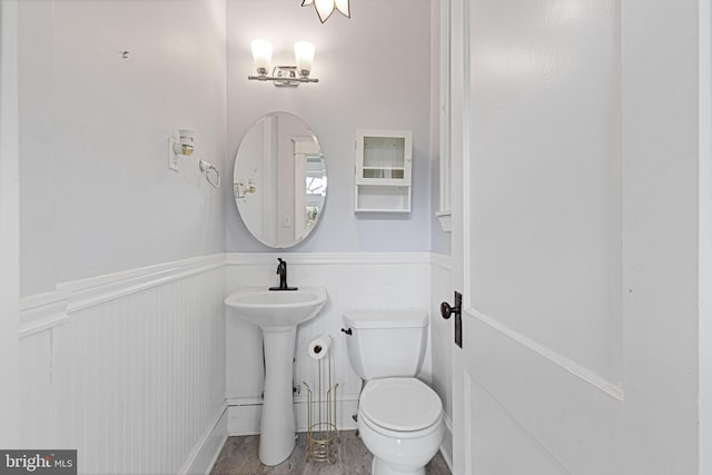 28 N Wakefield, Jeffersonville, PA 19403 - bathroom featuring wainscoting, toilet, a sink, and wood finished floors