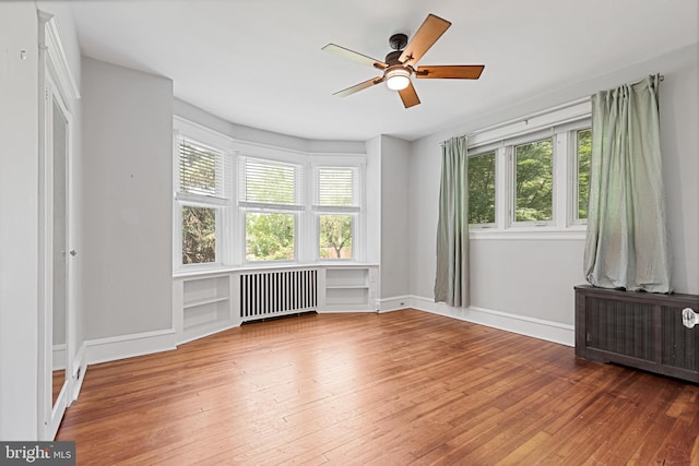28 N Wakefield, Jeffersonville, PA 19403 - empty room with radiator heating unit, plenty of natural light, and hardwood / wood-style flooring