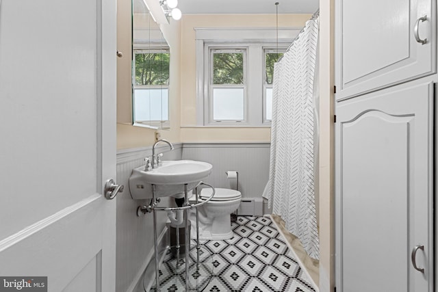 28 N Wakefield, Jeffersonville, PA 19403 - full bathroom with wainscoting, toilet, curtained shower, a sink, and a baseboard radiator