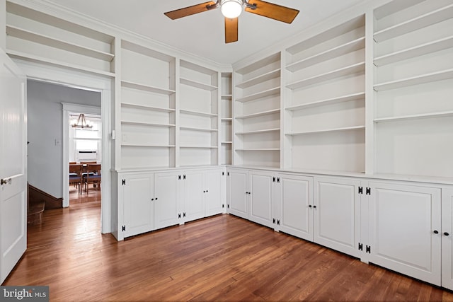 28 N Wakefield, Jeffersonville, PA 19403 - spare room featuring ceiling fan, dark wood-style flooring, a chandelier, built in shelves, and crown molding