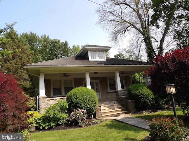 28 N Wakefield, Jeffersonville, PA 19403 - view of front of house featuring a ceiling fan, covered porch, stone siding, and a front yard