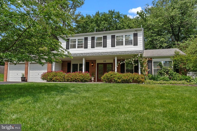 95 Meadowfield Dr, Southampton, PA 18966 - traditional-style house with a front lawn, asphalt driveway, brick siding, and covered porch