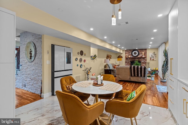 95 Meadowfield Dr, Southampton, PA 18966 - dining room with light marble finish flooring, recessed lighting, a brick fireplace, and baseboards