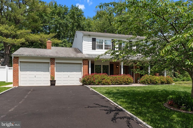 95 Meadowfield Dr, Southampton, PA 18966 - view of front of property with an attached garage, asphalt driveway, brick siding, and a chimney