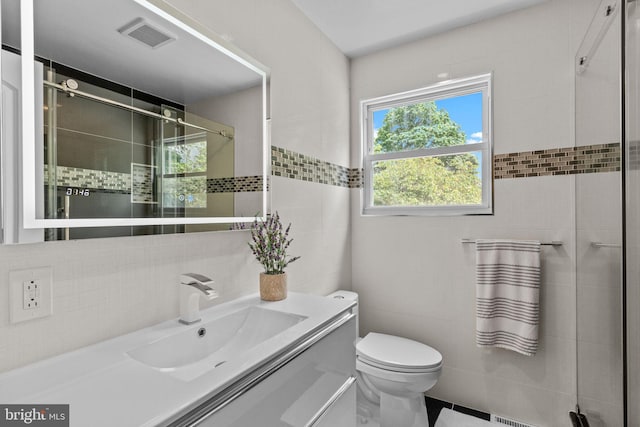 95 Meadowfield Dr, Southampton, PA 18966 - bathroom featuring tile walls, vanity, toilet, and a tile shower