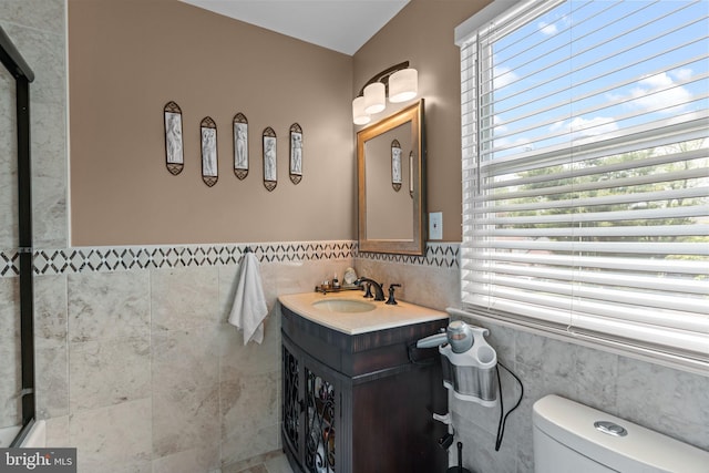 95 Meadowfield Dr, Southampton, PA 18966 - bathroom with tile walls, healthy amount of natural light, vanity, toilet, and a wainscoted wall