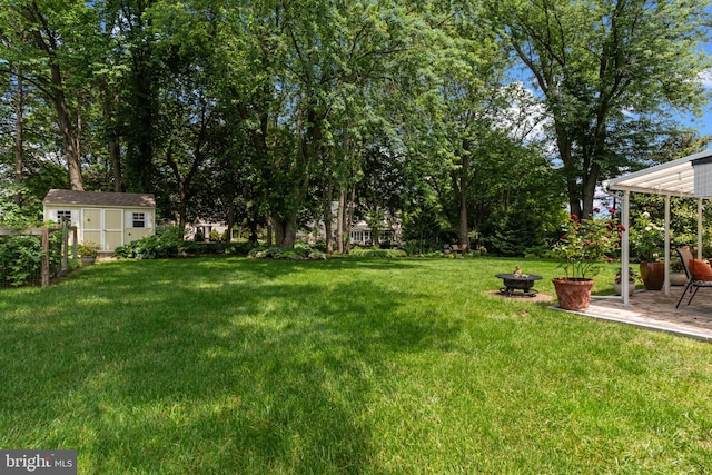 95 Meadowfield Dr, Southampton, PA 18966 - view of grassy yard featuring a fire pit, a patio area, and view of wooded area