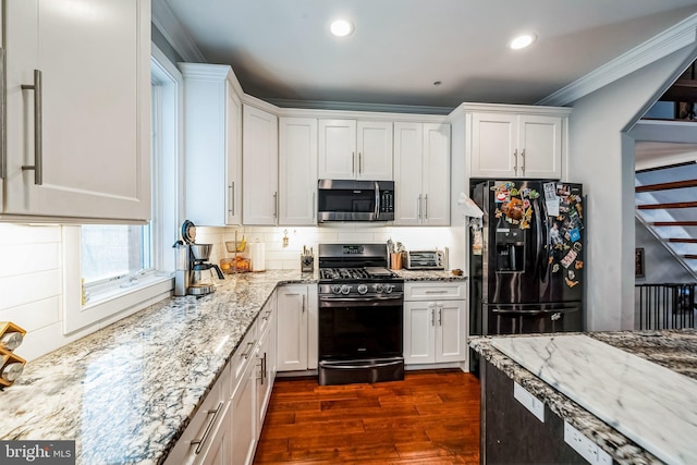 1603 S 6th St, Philadelphia, PA 19148 - kitchen featuring stainless steel microwave, range with gas stovetop, black refrigerator with ice dispenser, dark wood finished floors, and white cabinetry