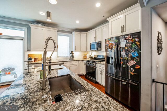 1603 S 6th St, Philadelphia, PA 19148 - kitchen with appliances with stainless steel finishes, tasteful backsplash, dark wood-style floors, white cabinets, and crown molding
