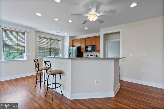 902 Macphail Woods Xing Unit 2I, Bel Air, MD 21015 - kitchen featuring black microwave, freestanding refrigerator, recessed lighting, a breakfast bar, and dark wood-type flooring
