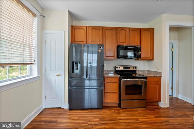 902 Macphail Woods Xing Unit 2I, Bel Air, MD 21015 - kitchen with appliances with stainless steel finishes, dark wood-style flooring, baseboards, light stone countertops, and brown cabinetry