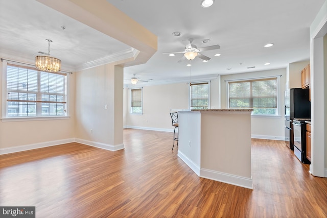 902 Macphail Woods Xing Unit 2I, Bel Air, MD 21015 - kitchen featuring a kitchen bar, ornamental molding, ceiling fan, light wood-type flooring, and a chandelier