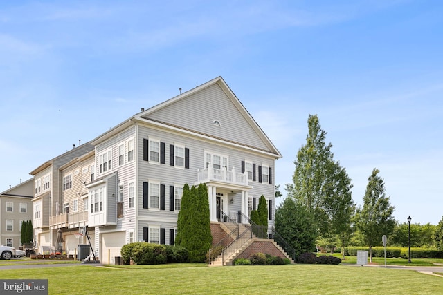 11821 Whitworth Cannon Ln, Bristow, VA 20136 - view of front of property with a balcony, a front lawn, and stairway