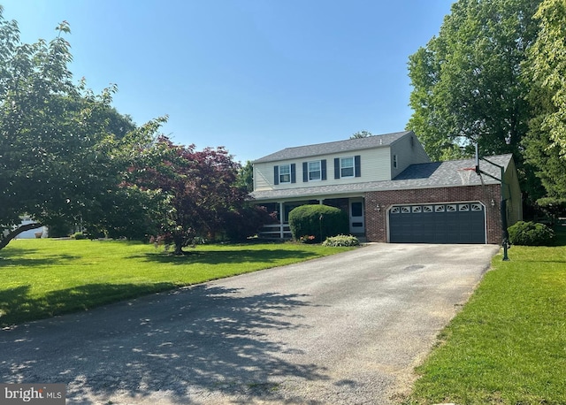 48 Carlson Way, Downingtown, PA 19335 - view of front of property featuring driveway, a garage, a front yard, and brick siding