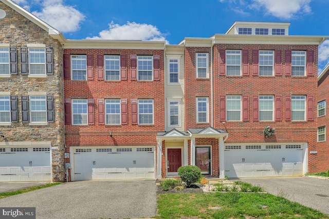 12310 Sandstone St, Waldorf, MD 20601 - multi unit property featuring an attached garage, driveway, and brick siding