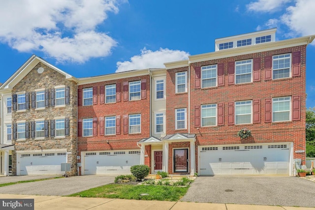 12310 Sandstone St, Waldorf, MD 20601 - townhome / multi-family property featuring a garage, driveway, and brick siding