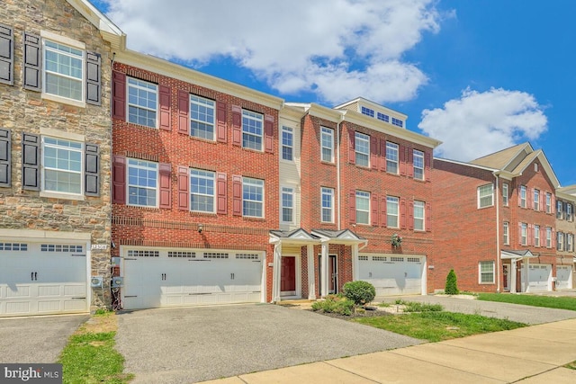 12310 Sandstone St, Waldorf, MD 20601 - view of front facade featuring an attached garage, driveway, and brick siding