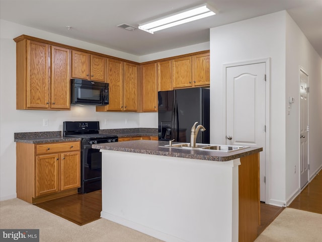 18238 Hurricane Ct, Hagerstown, MD 21740 - kitchen featuring black appliances, a sink, dark countertops, a kitchen island with sink, and brown cabinets