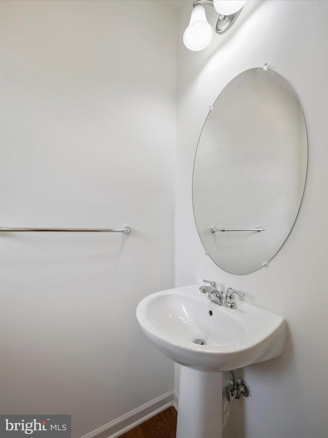 18238 Hurricane Ct, Hagerstown, MD 21740 - bathroom featuring wood finished floors, baseboards, and a sink