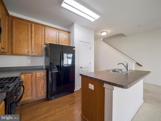 18238 Hurricane Ct, Hagerstown, MD 21740 - kitchen with black appliances, dark countertops, a sink, and brown cabinetry
