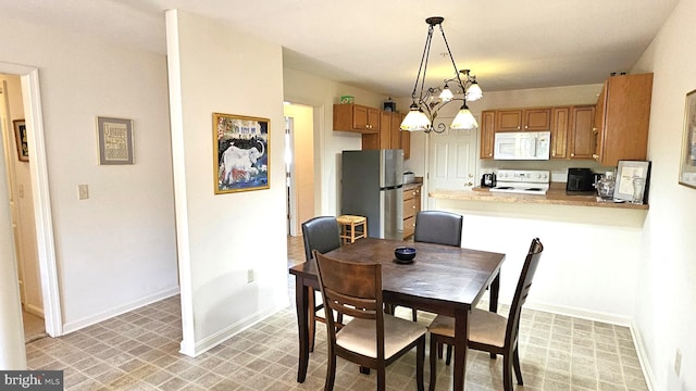 5934 Tappan Ln, Salisbury, MD 21801 - dining room featuring baseboards, a chandelier, and light flooring