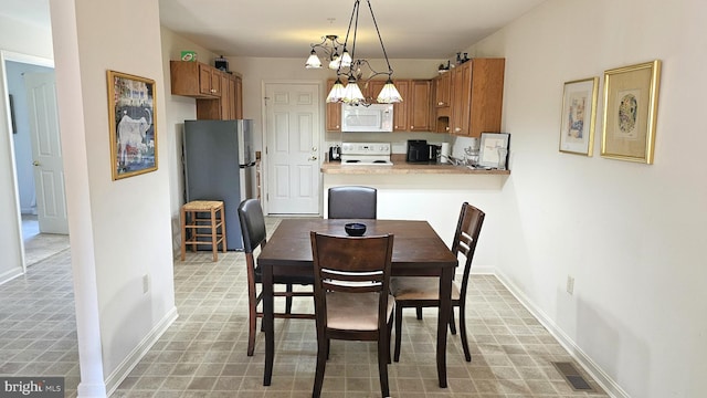 5934 Tappan Ln, Salisbury, MD 21801 - dining space with a chandelier, baseboards, and light flooring