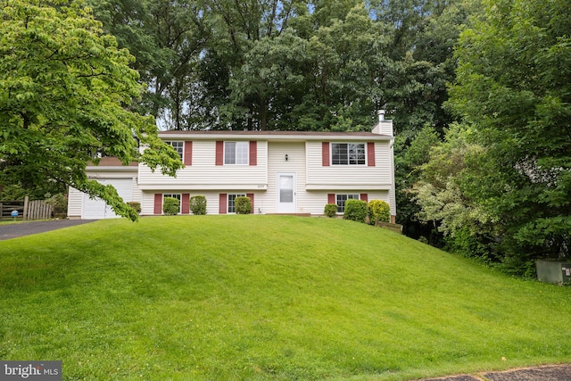 10729 Freds Oak Ct, Burke, VA 22015 - bi-level home featuring a chimney, a front yard, and driveway