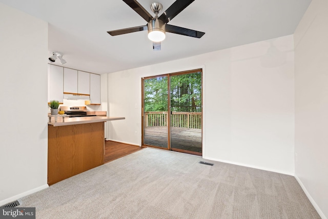 10729 Freds Oak Ct, Burke, VA 22015 - kitchen featuring dark colored carpet, ceiling fan, electric stove, white cabinetry, and under cabinet range hood
