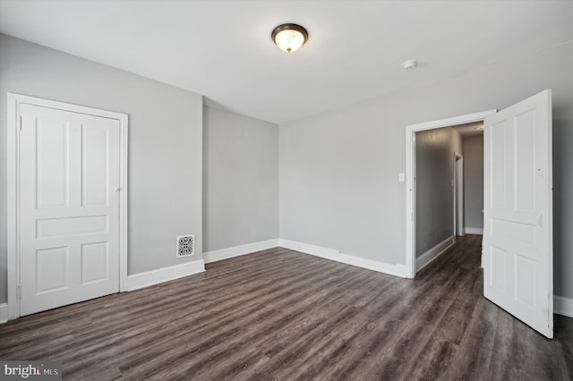 2434 N 26th St, Philadelphia, PA 19132 - spare room with dark wood-type flooring, baseboards, and a smoke detector