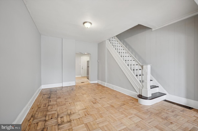 2434 N 26th St, Philadelphia, PA 19132 - below grade area featuring arched walkways, stairs, baseboards, and freestanding refrigerator
