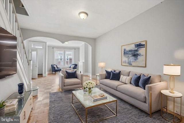 2434 N 26th St, Philadelphia, PA 19132 - living area with arched walkways, stairs, and baseboards