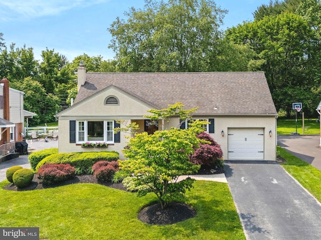 231 Rogers, Eagleville, PA 19403 - view of front facade with a garage, stucco siding, driveway, and a front lawn