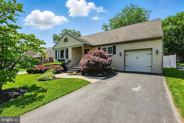 231 Rogers, Eagleville, PA 19403 - view of front of home with a garage, a front lawn, and stucco siding