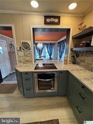 333 Decker Ferry Rd, Mount Bethel, PA 18343 - kitchen with stainless steel oven, ornamental molding, stovetop, gray cabinetry, and light wood-style flooring