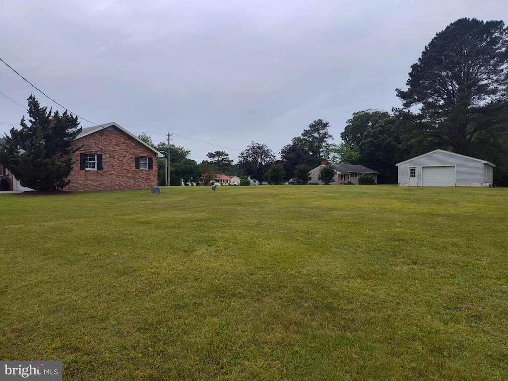 350 Tilghman Rd, Salisbury, MD 21804 - view of green lawn featuring a garage and an outdoor structure