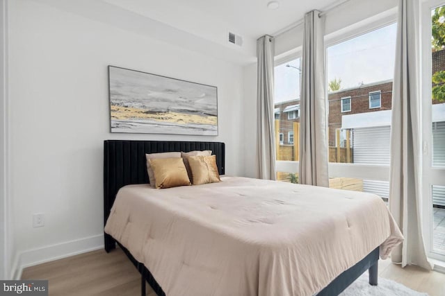 705 Quincy NE Unit 3C, Washington, DC 20017 - bedroom with wood finished floors, multiple windows, and baseboards