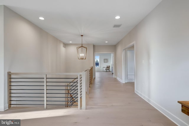 6654 Chilton Ct, Mclean, VA 22101 - hallway featuring an upstairs landing, a chandelier, recessed lighting, light wood-style floors, and baseboards