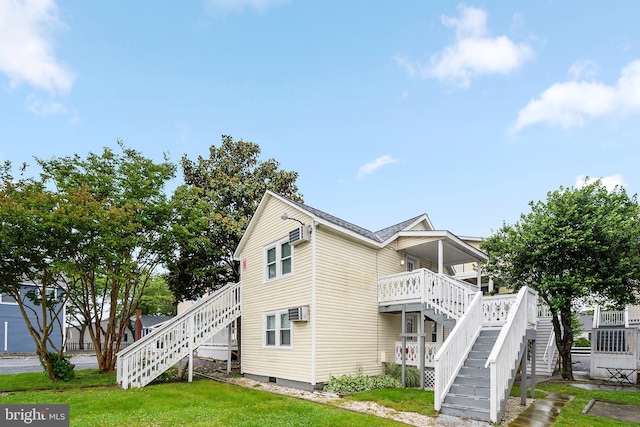 203 5th St Unit 34, Ocean City, MD 21842 - view of side of property featuring stairs, a lawn, and a wall mounted AC